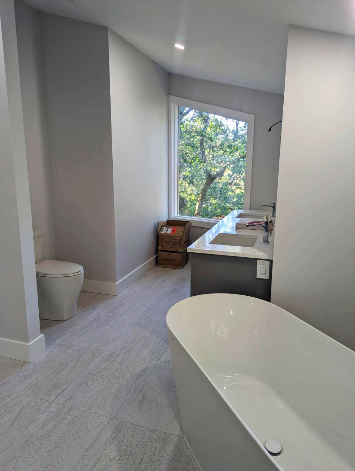 Light gray bathroom with an oversized porcelain tub.